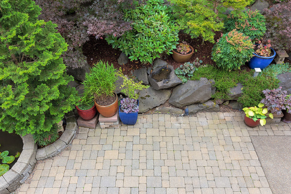 Landscaping performed on a back yard. Stone tiles were installed into a backyard in Burnaby. 